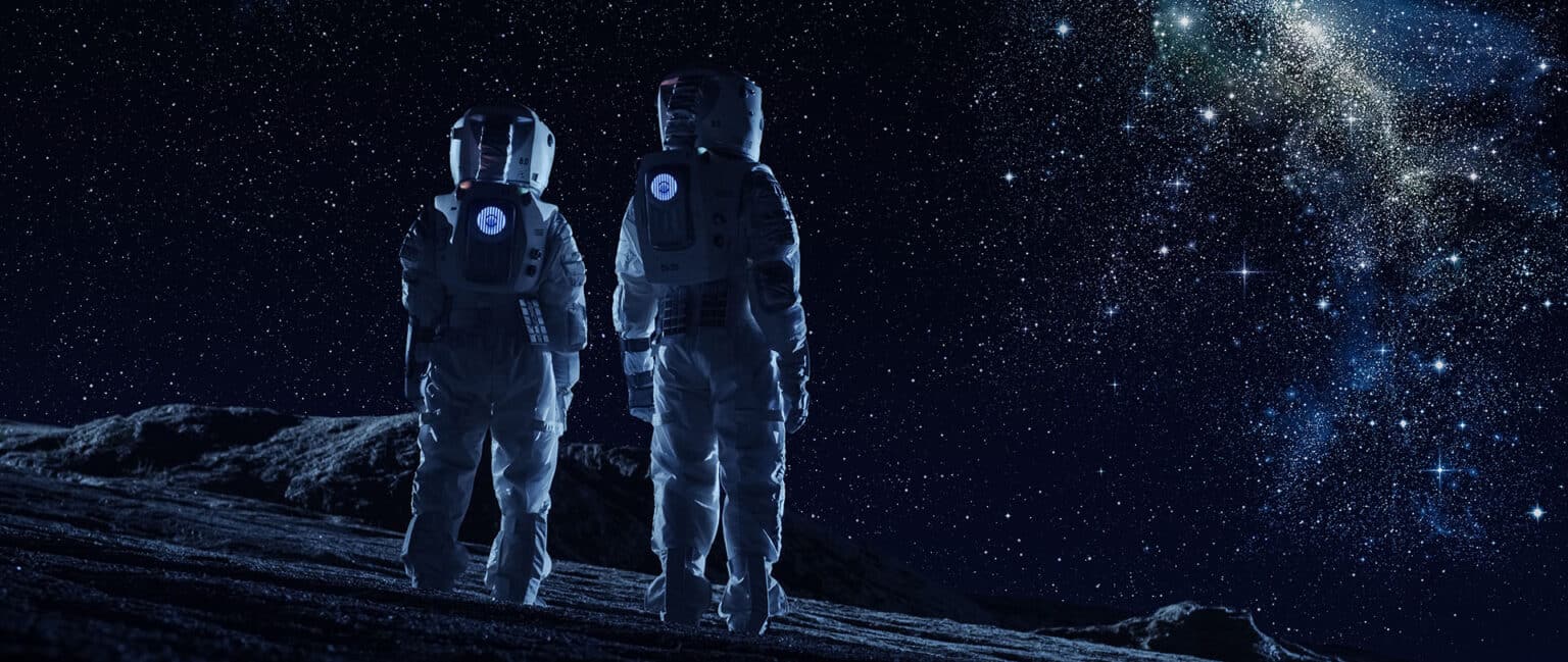 Crew of Two Astronauts in Space Suits Standing on the Moon Looking at the The Milky Way Galaxy.